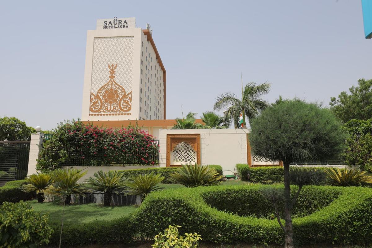 a resort with a garden and a building at Saura Hotel, Agra - A Club Mahindra Associate in Agra