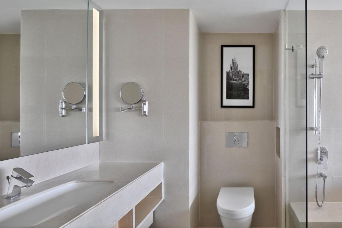 a white bathroom with a sink and a toilet at The Westin Mumbai Powai Lake in Mumbai