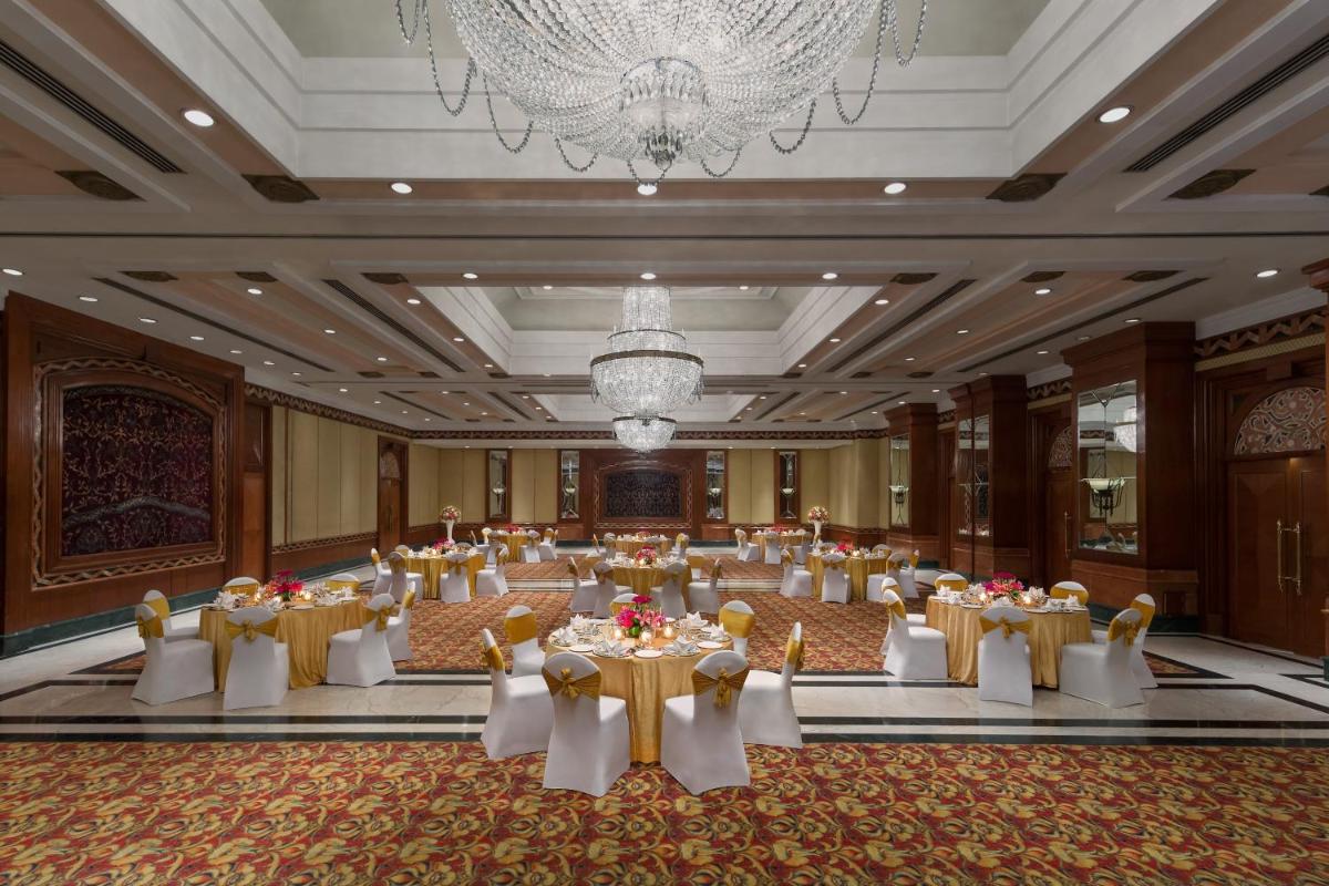 a banquet hall with tables and chairs and a chandelier at Sheraton New Delhi Hotel in New Delhi a banquet hall with tables and chairs and a chandelier at Sheraton New Delhi Hotel in New Delhi