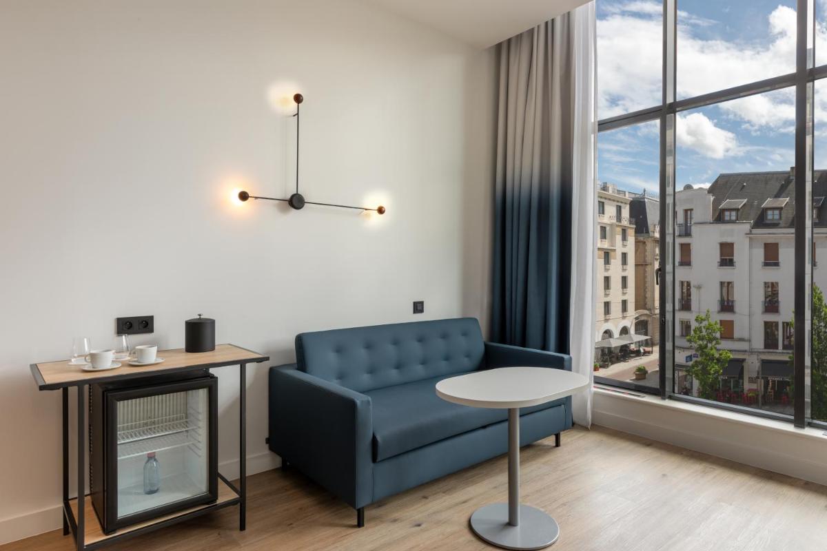 Coin salon dans l'établissement Aloft Dijon