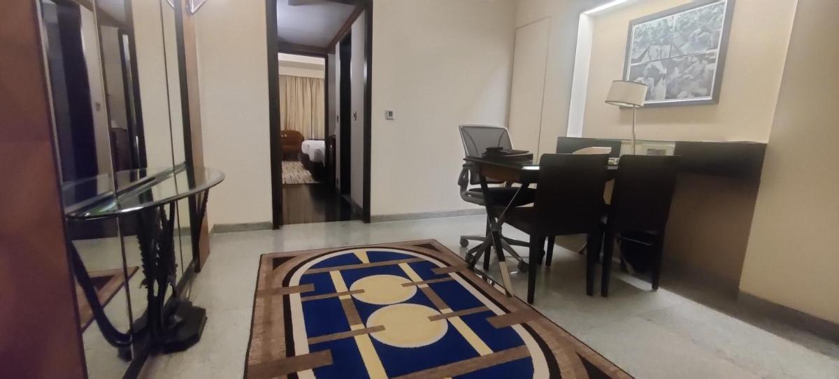 a living room with a table and a rug at Hotel Marine Plaza in Mumbai