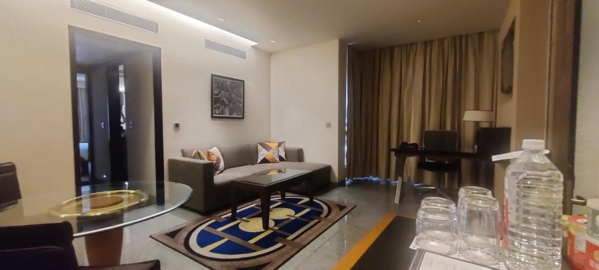a living room with a couch and a glass table at Hotel Marine Plaza in Mumbai