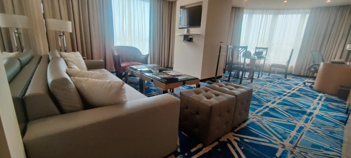 a living room with a couch and a table at Hotel Marine Plaza in Mumbai