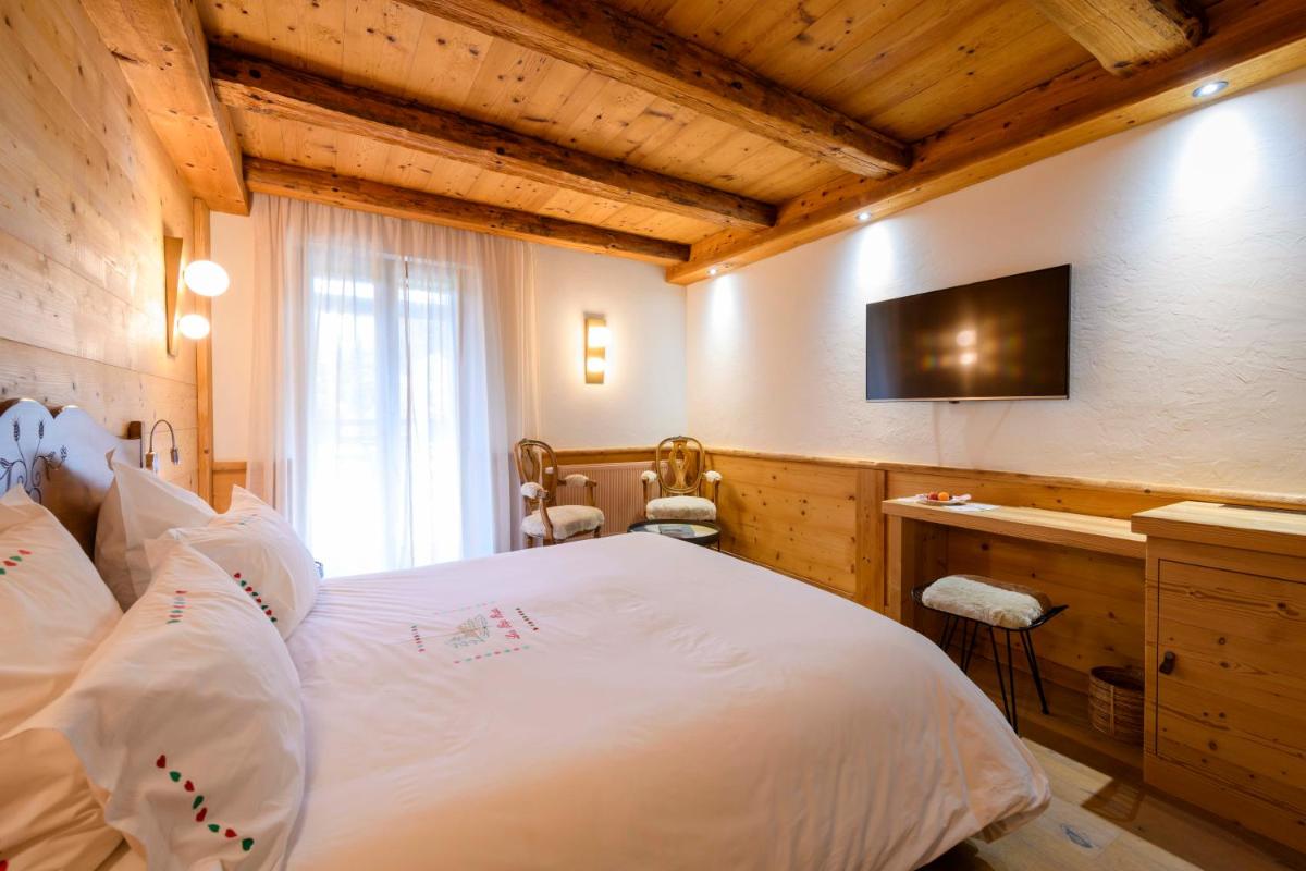 Un ou plusieurs lits dans un hébergement de l'établissement Hôtel-Restaurant Les Bas-Rupts, Singuliers Hôtel