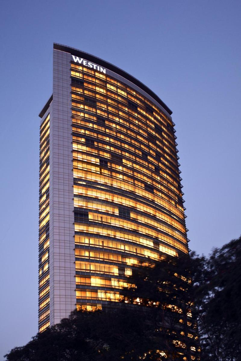 a tall building with its lights on at The Westin Mumbai Garden City in Mumbai