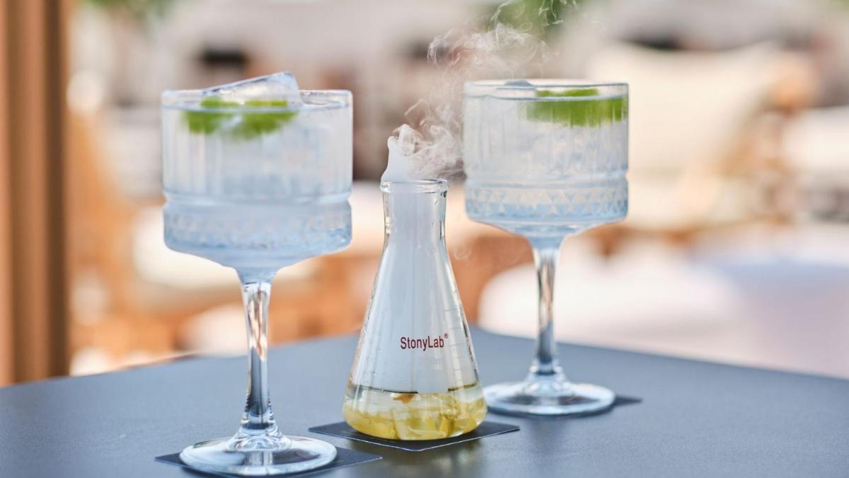 tres copas de vino sentadas en una mesa con una botella en ESTIMAR Valencia, en Valencia