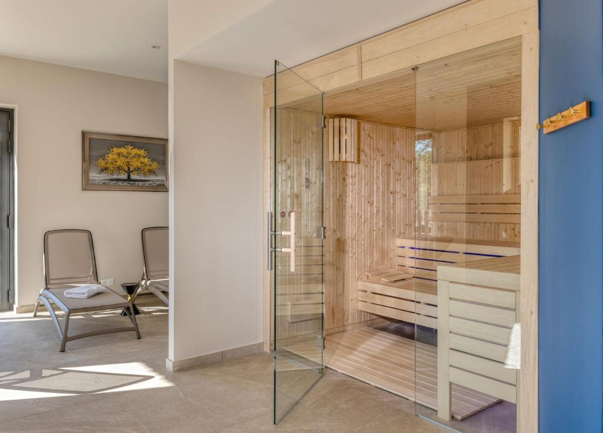 une cloison vitrée dans une pièce avec un bureau et des chaises dans l'établissement Mas De La Senancole & Spa, à Gordes