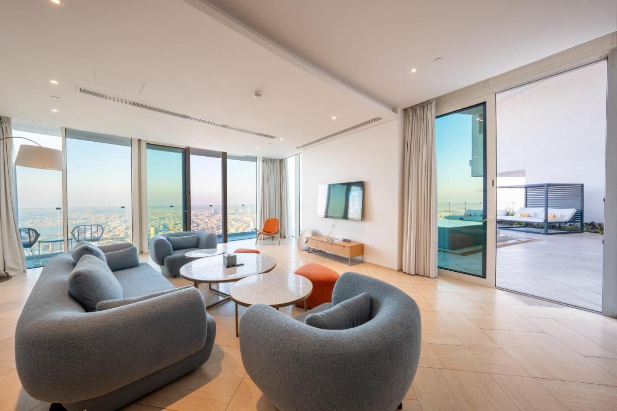 a living room with two couches and a table at FIVE Jumeirah Village in Dubai