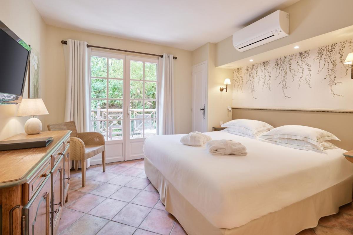 Un ou plusieurs lits dans un hébergement de l'établissement La Bastide du Calalou Hotel & Spa, BW Signature Collection