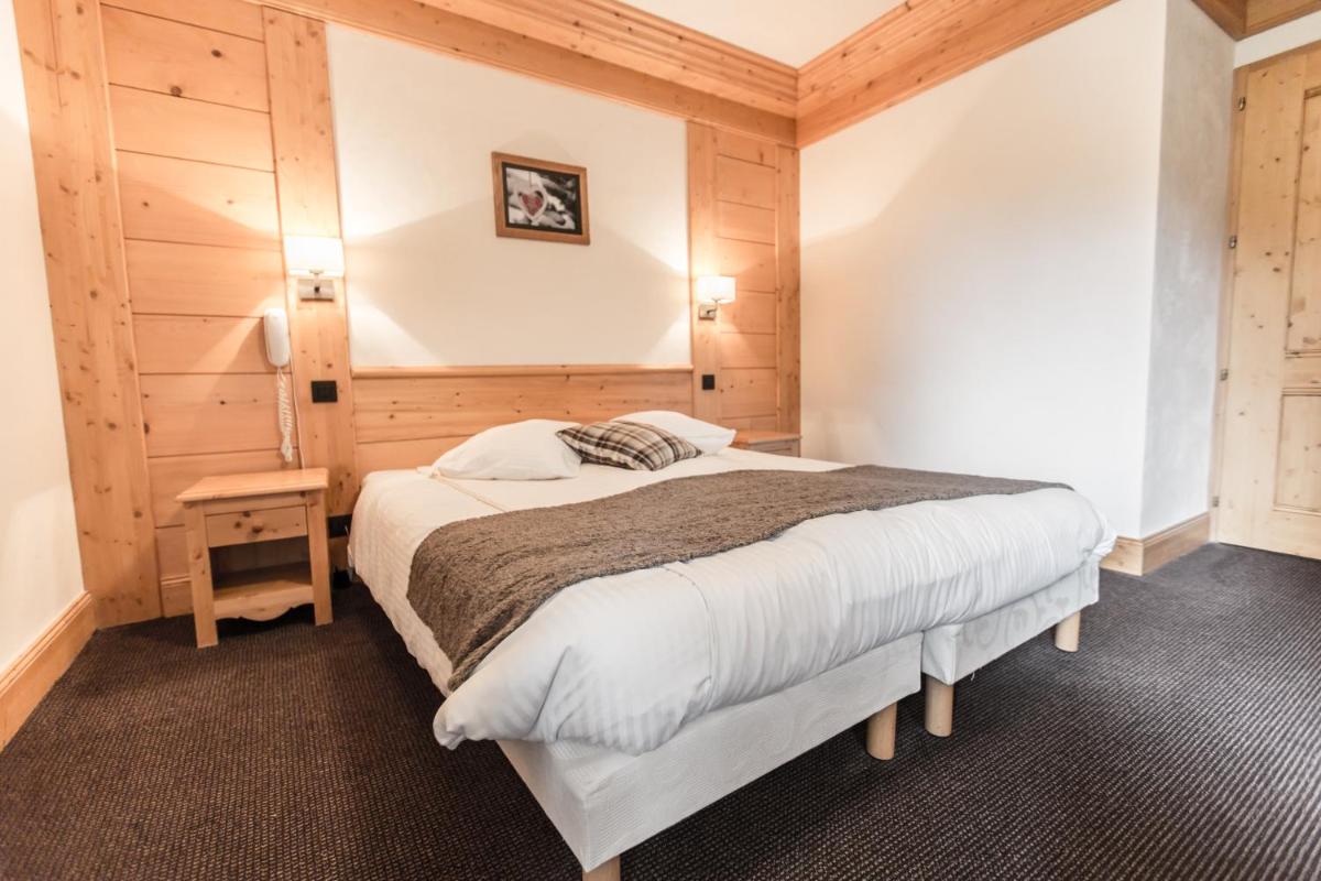 Un ou plusieurs lits dans un hébergement de l'établissement Hotel Club Le Crêt