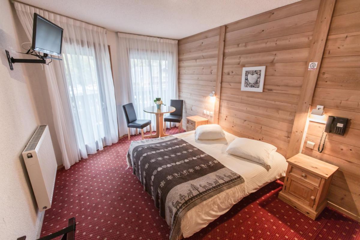 Un ou plusieurs lits dans un hébergement de l'établissement Hotel Club Le Crêt
