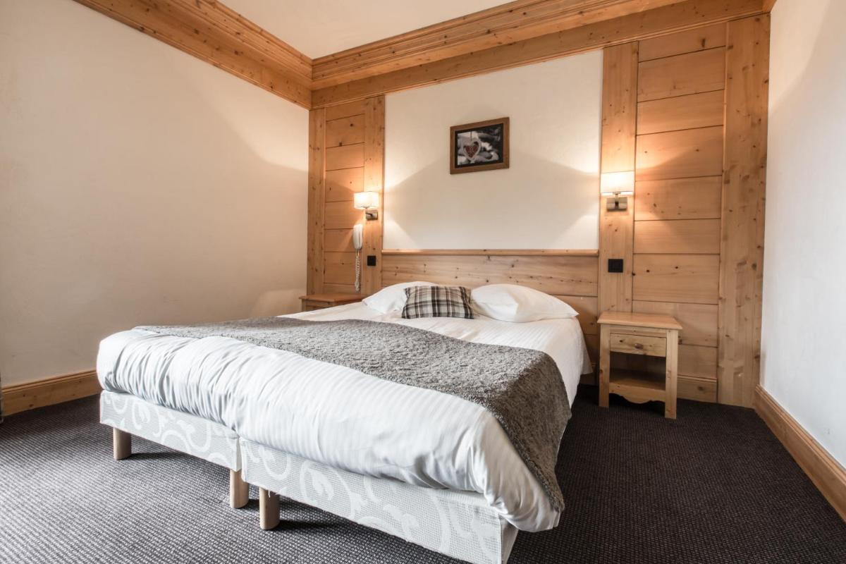 Un ou plusieurs lits dans un hébergement de l'établissement Hotel Club Le Crêt