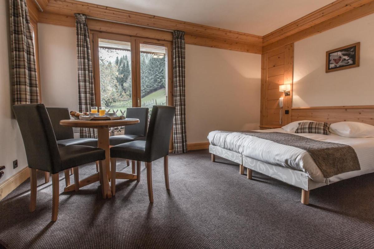Un ou plusieurs lits dans un hébergement de l'établissement Hotel Club Le Crêt
