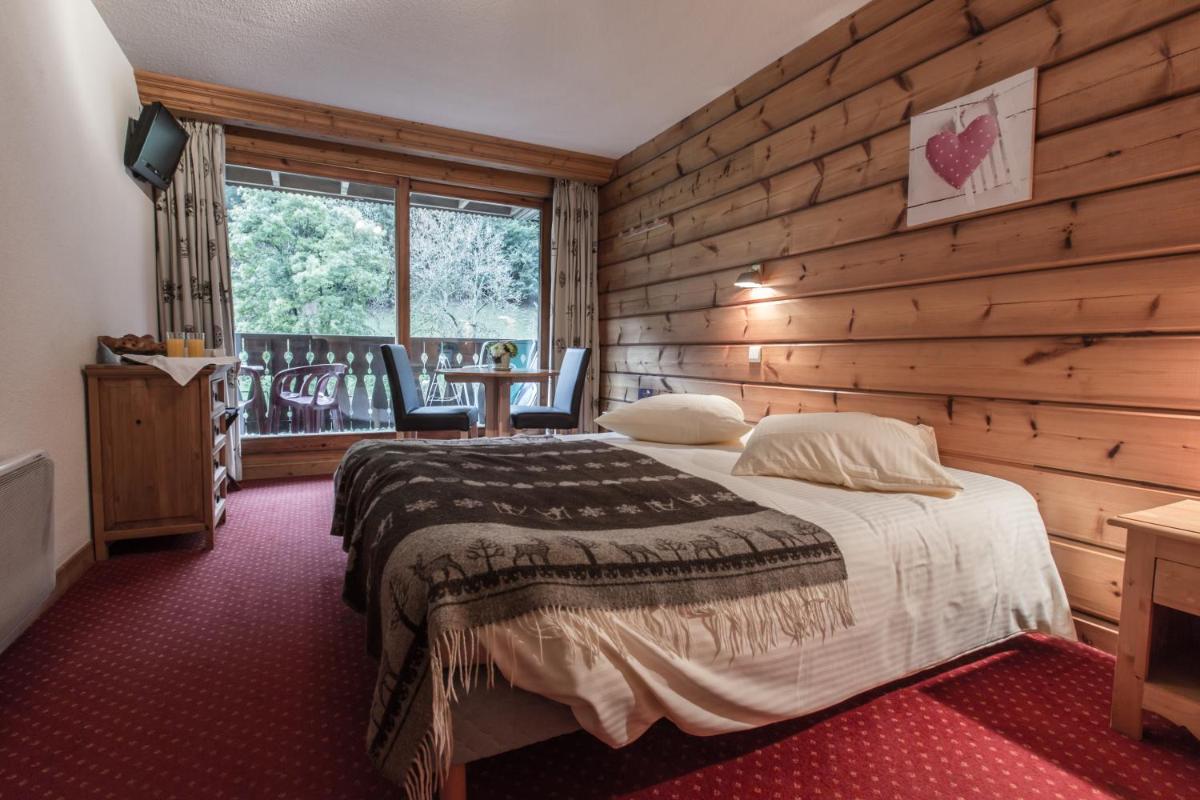 Un ou plusieurs lits dans un hébergement de l'établissement Hotel Club Le Crêt