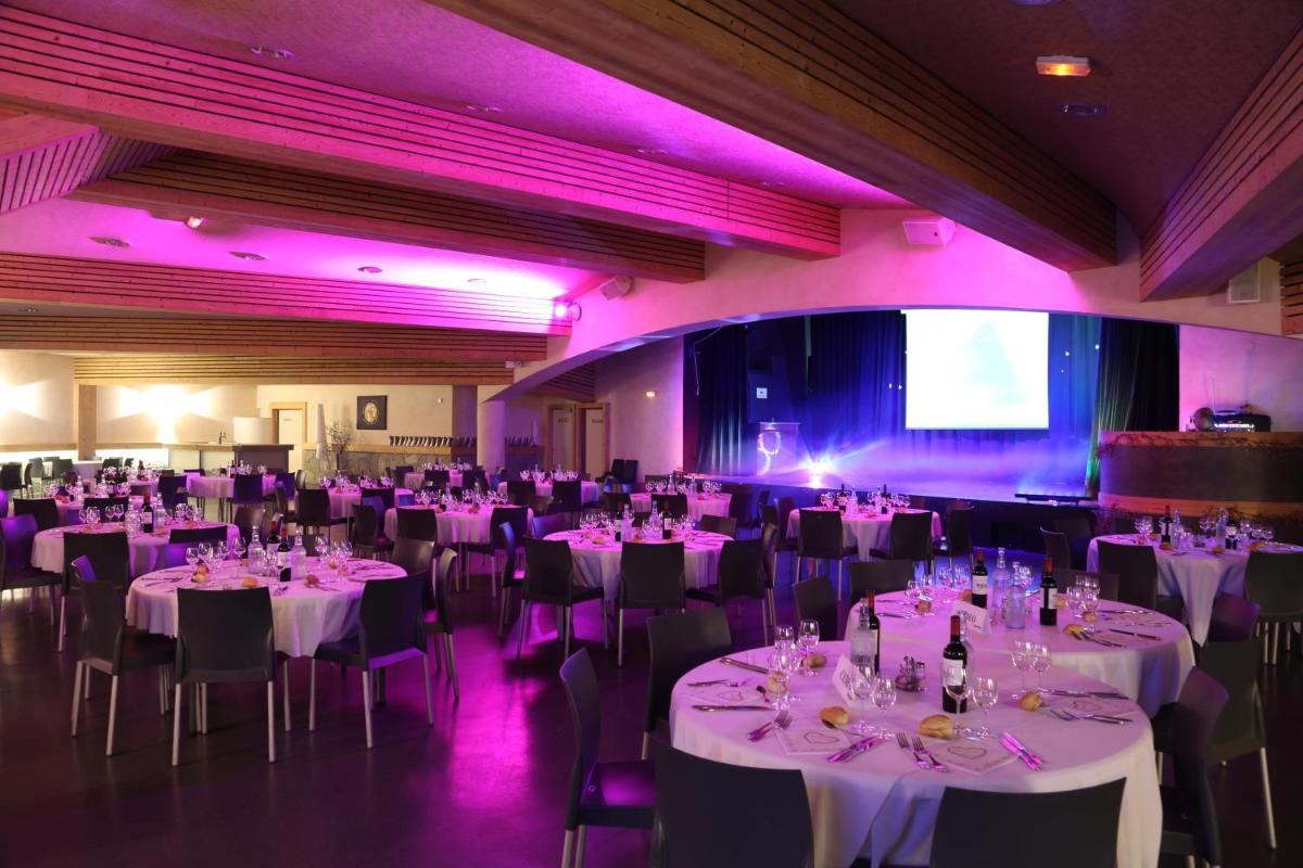 une salle de banquet avec des tables et des chaises blanches dans l'établissement Hotel Club Le Crêt, à Morzine 46 autres photos
