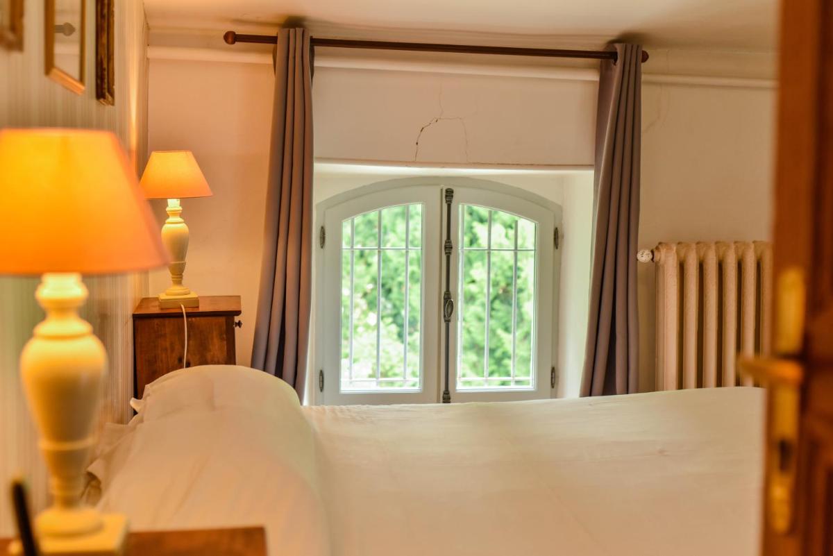 Un ou plusieurs lits dans un hébergement de l'établissement Hotel Logis - Chateau de Beauregard