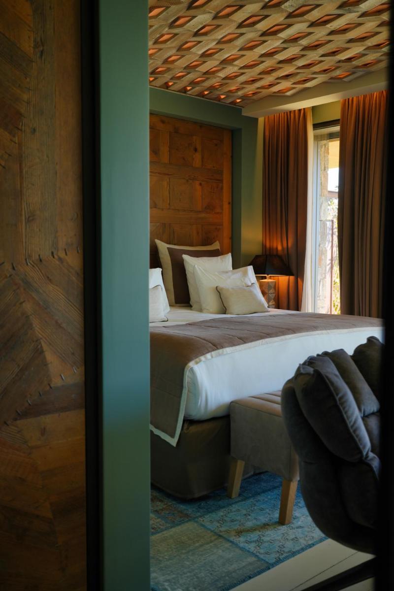 Un ou plusieurs lits dans un hébergement de l'établissement Les Regalia Hôtel & Spa
