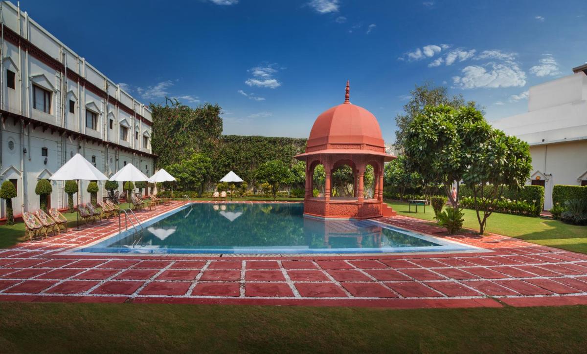 a swimming pool with a gazebo next to a building at The Grand Imperial - Heritage Hotel in Agra