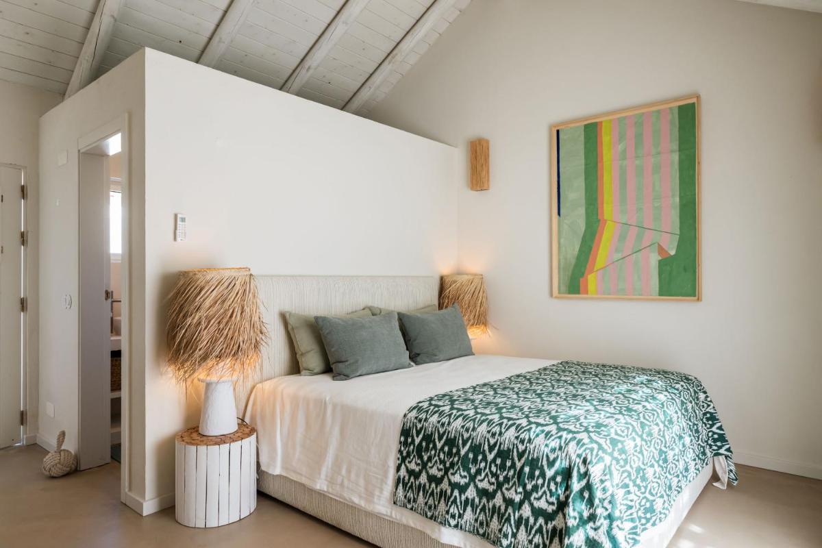 Uma cama ou camas num quarto em Independente Comporta