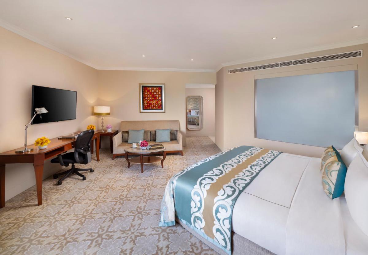 a hotel room with a bed and a desk at Taj Palace, New Delhi in New Delhi a hotel room with a bed and a desk at Taj Palace, New Delhi in New Delhi