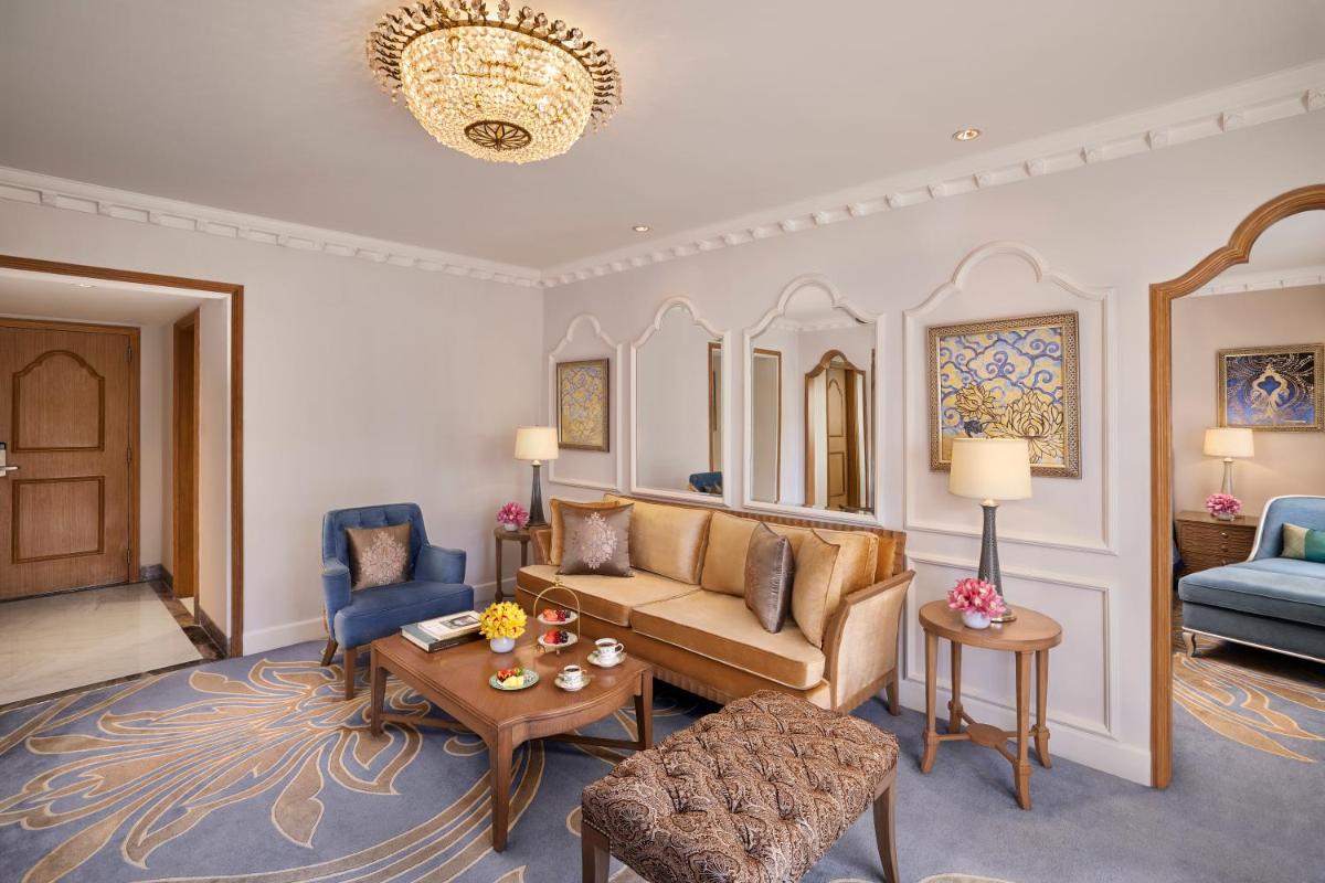 a living room with a couch and a table at Taj Palace, New Delhi in New Delhi a living room with a couch and a table at Taj Palace, New Delhi in New Delhi