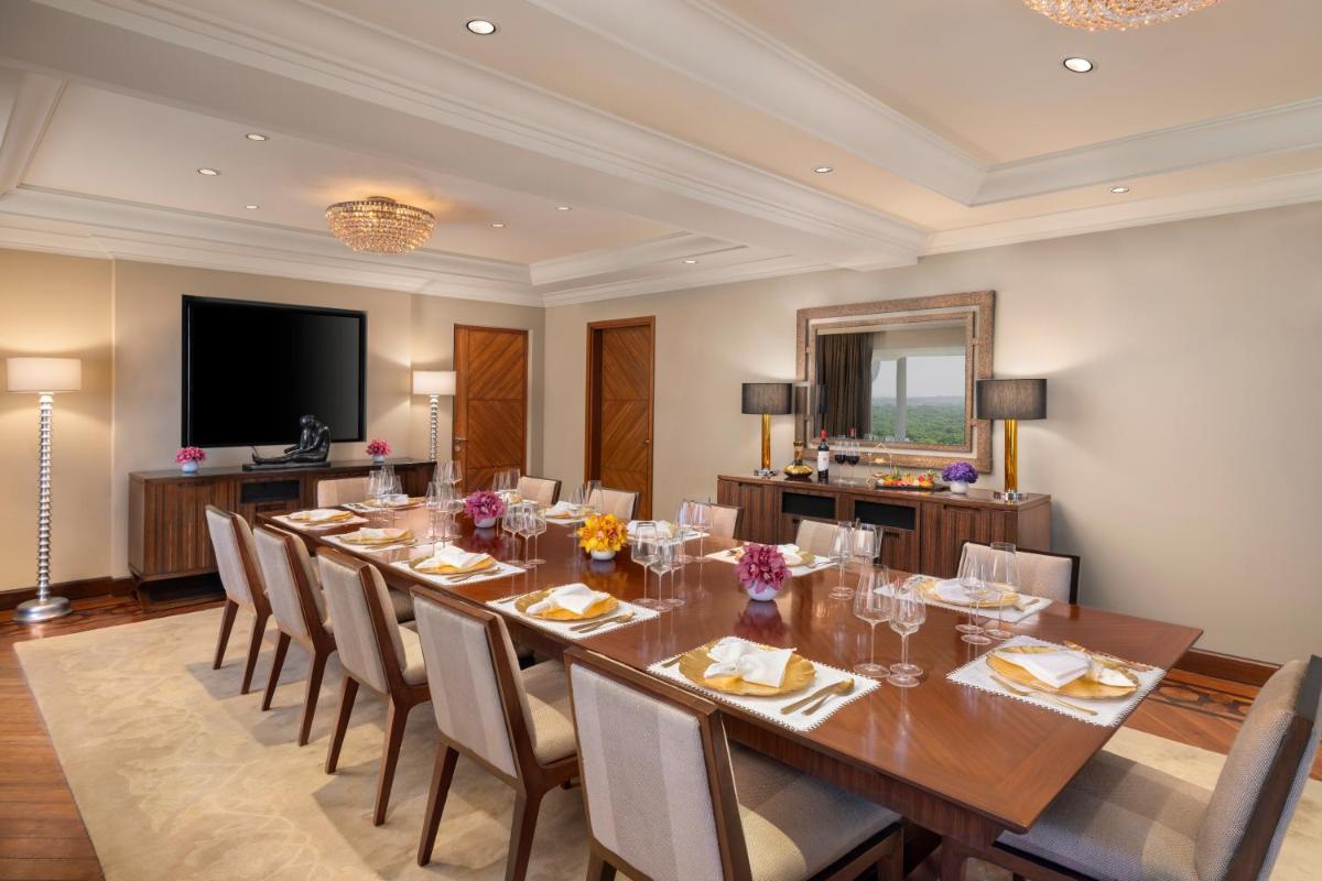 a large dining room with a long table and chairs at Taj Palace, New Delhi in New Delhi a large dining room with a long table and chairs at Taj Palace, New Delhi in New Delhi