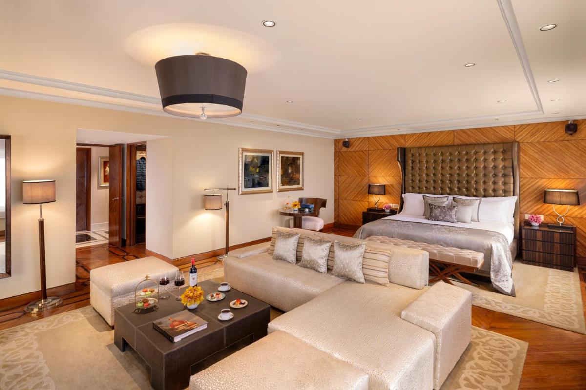 a living room with a bed and a couch at Taj Palace, New Delhi in New Delhi a living room with a bed and a couch at Taj Palace, New Delhi in New Delhi