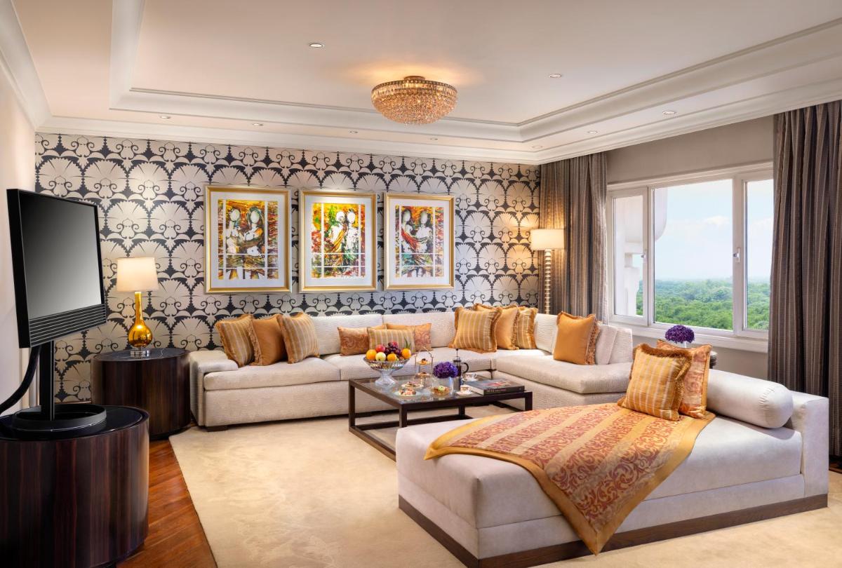 a living room with a couch and a tv at Taj Palace, New Delhi in New Delhi a living room with a couch and a tv at Taj Palace, New Delhi in New Delhi
