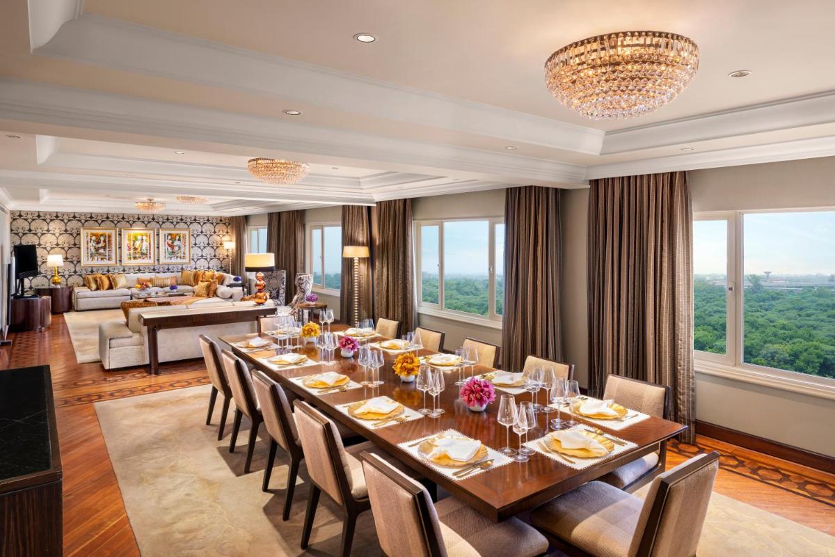 a dining room with a long table and chairs at Taj Palace, New Delhi in New Delhi a dining room with a long table and chairs at Taj Palace, New Delhi in New Delhi