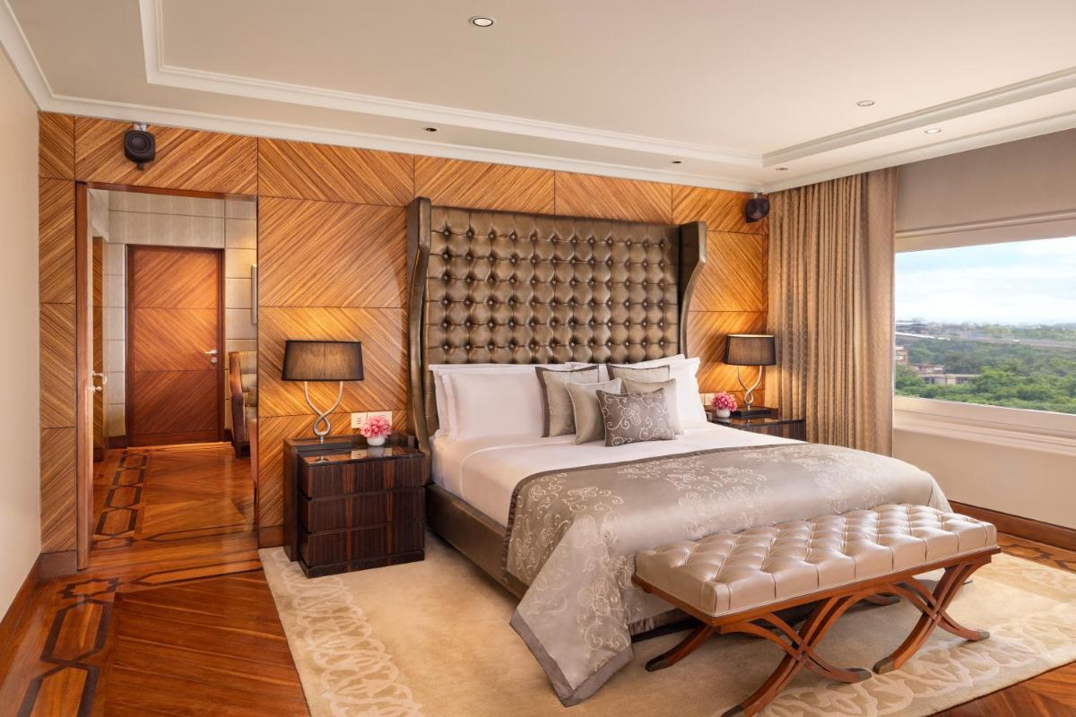 a bedroom with a large bed and a window at Taj Palace, New Delhi in New Delhi a bedroom with a large bed and a window at Taj Palace, New Delhi in New Delhi