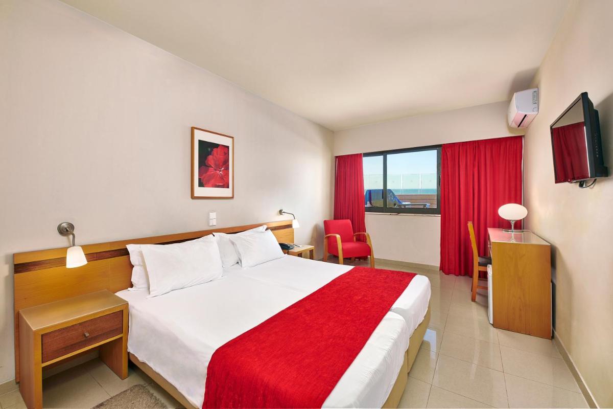 Uma cama ou camas num quarto em Rocamar Exclusive Hotel & Spa - Adults Only