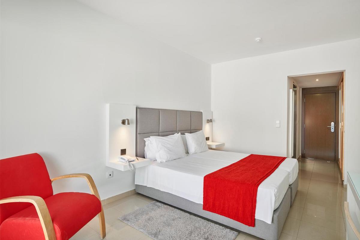 Uma cama ou camas num quarto em Rocamar Exclusive Hotel & Spa - Adults Only