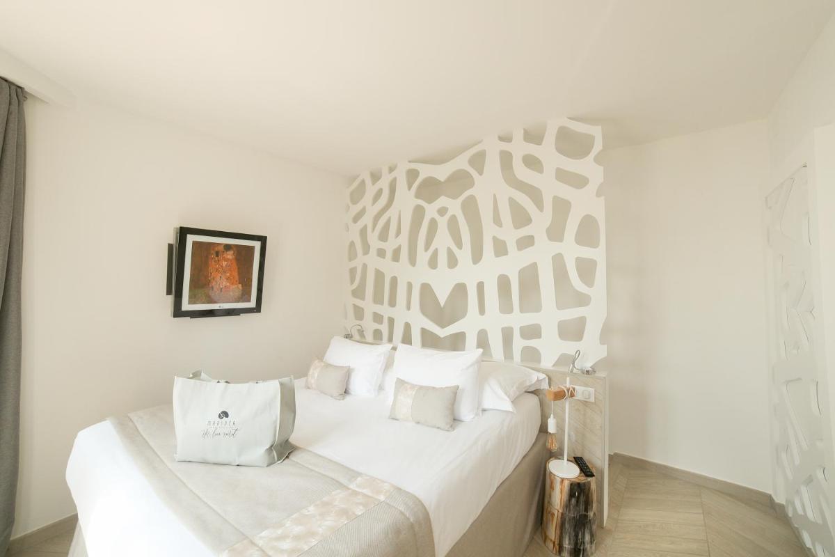 Un ou plusieurs lits dans un hébergement de l'établissement Hôtel Marinca & Spa