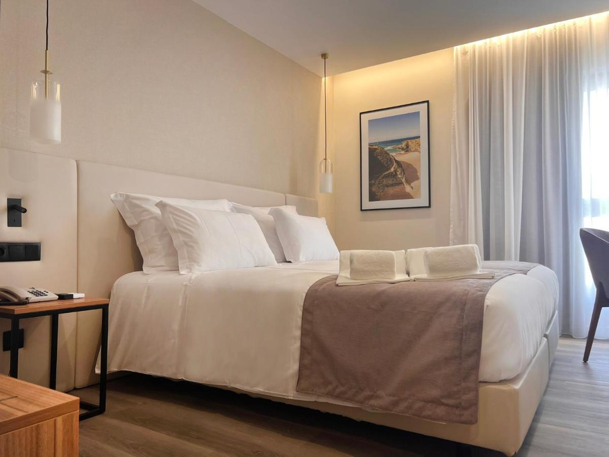 Uma cama ou camas num quarto em AP Sines - Costa Alentejana