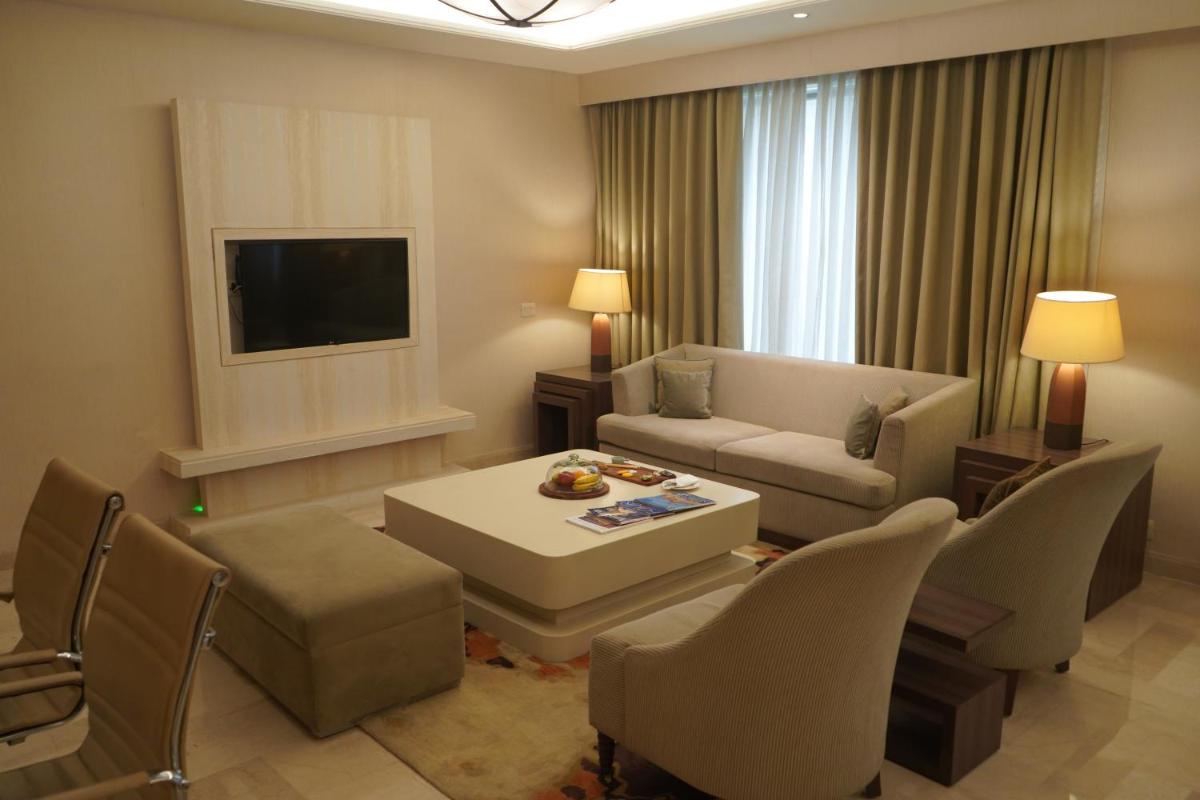 a living room with a couch and a table at DoubleTree by Hilton Agra in Agra