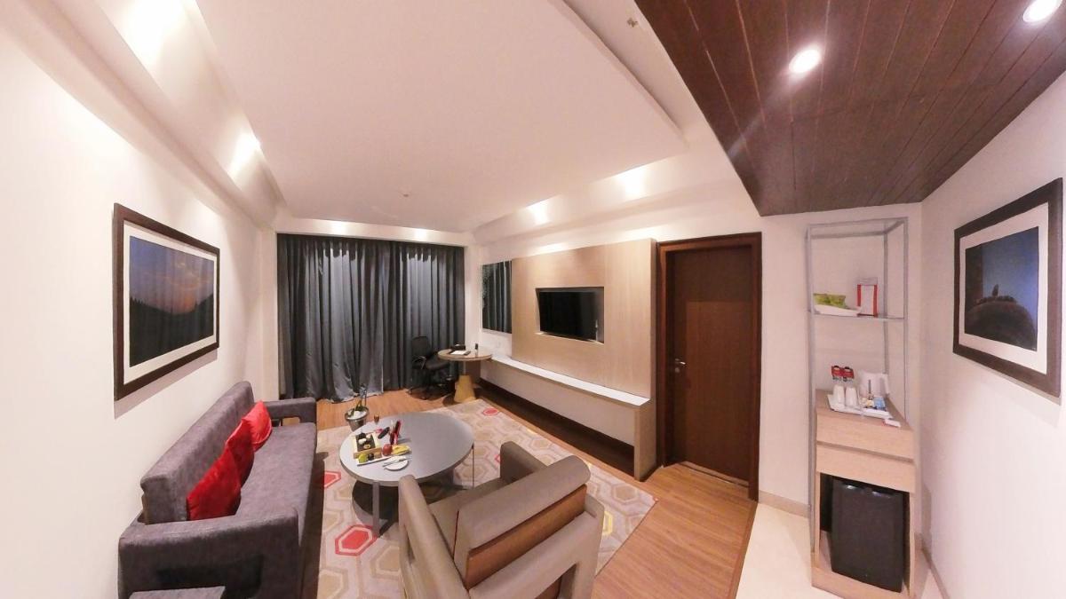 a living room with a couch and a table at Ramada Plaza by Wyndham Lucknow in Lucknow