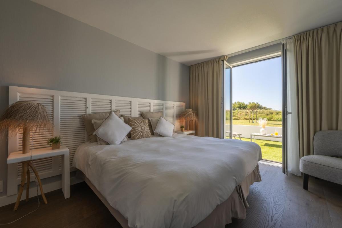 Un ou plusieurs lits dans un hébergement de l'établissement Hôtel Atalante - Relais Thalasso & Spa