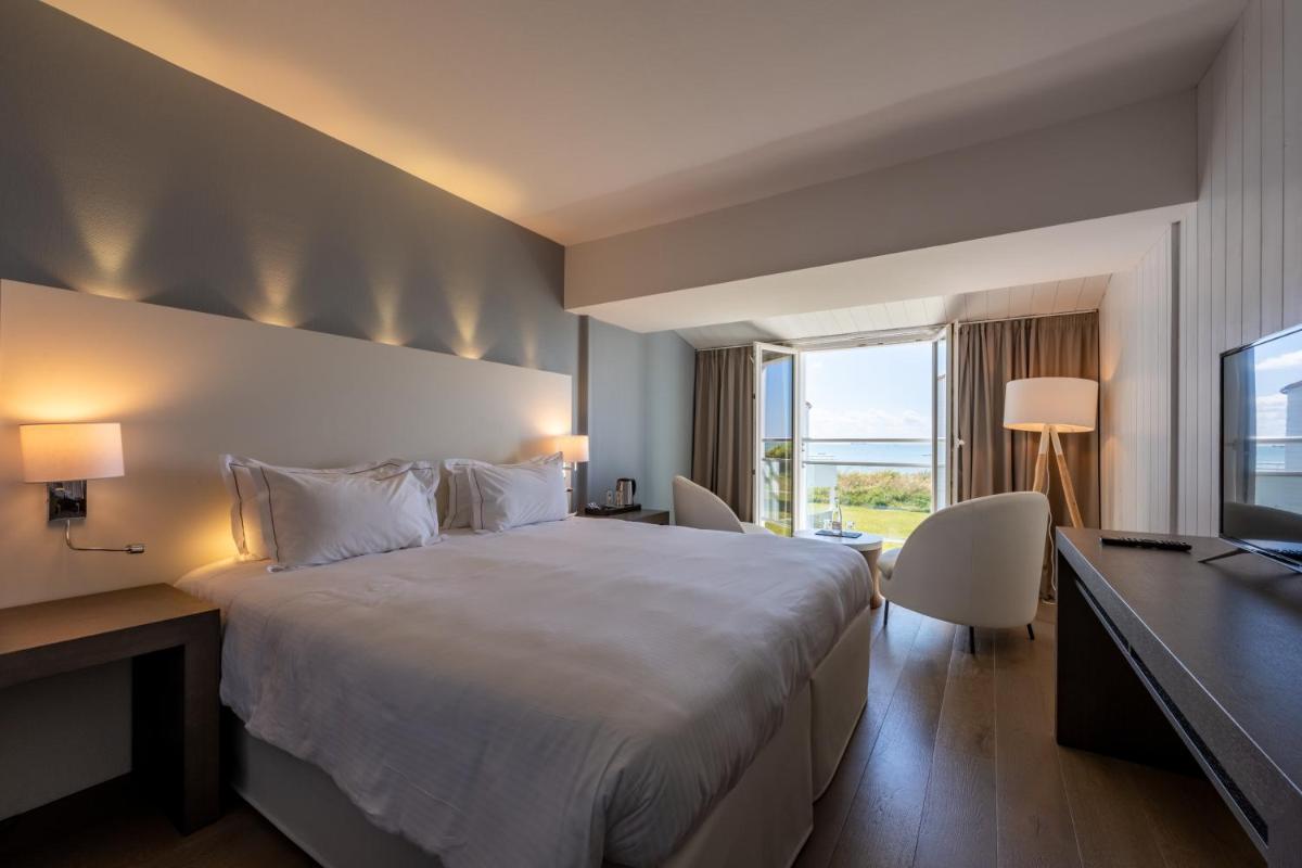 Un ou plusieurs lits dans un hébergement de l'établissement Hôtel Atalante - Relais Thalasso & Spa