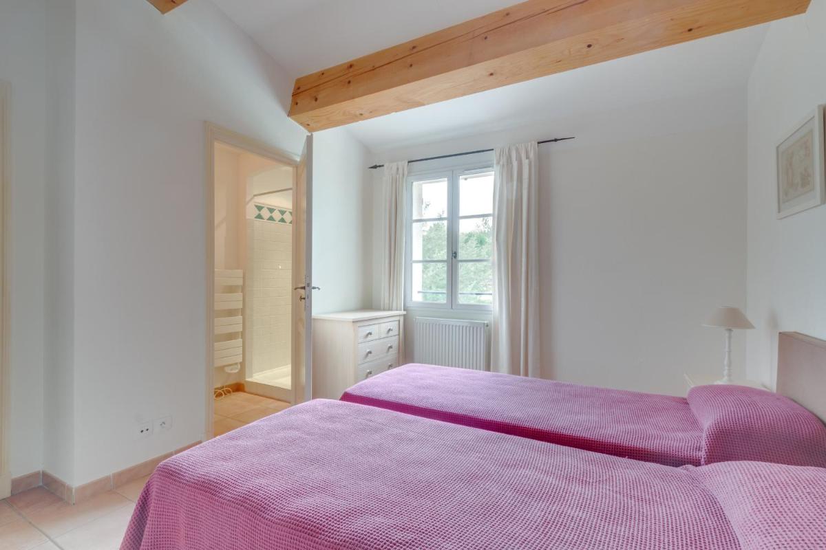 Un ou plusieurs lits dans un hébergement de l'établissement Les Appartements et Maisons du Domaine de Saint Endréol Golf & Spa Resort