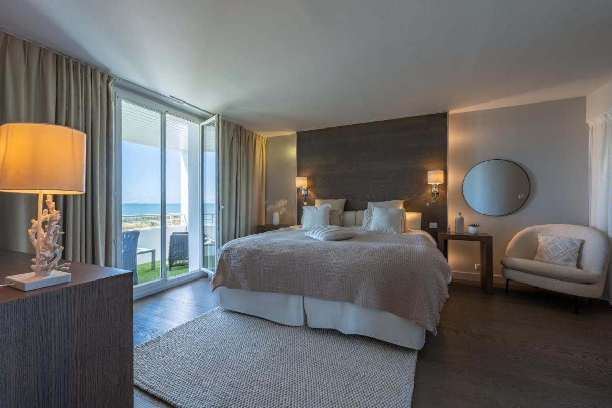 Un ou plusieurs lits dans un hébergement de l'établissement Hôtel Atalante - Relais Thalasso & Spa