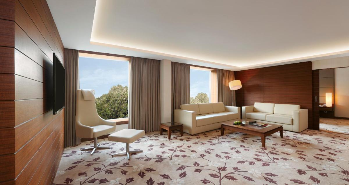 a living room with a couch and a table at Hilton Bangalore Embassy GolfLinks in Bengaluru