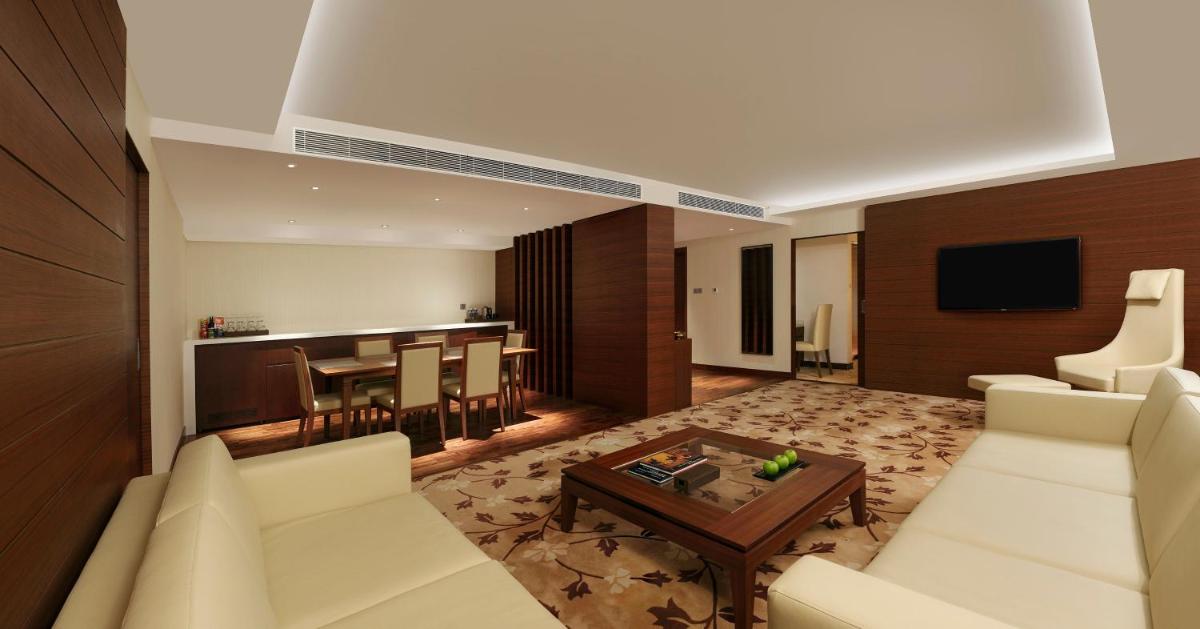 a living room with a couch and a table at Hilton Bangalore Embassy GolfLinks in Bengaluru