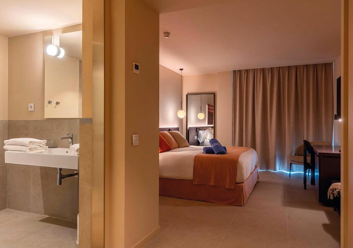 Cama o camas de una habitación en AQUA Hotel Promenade & Spa 4Sup