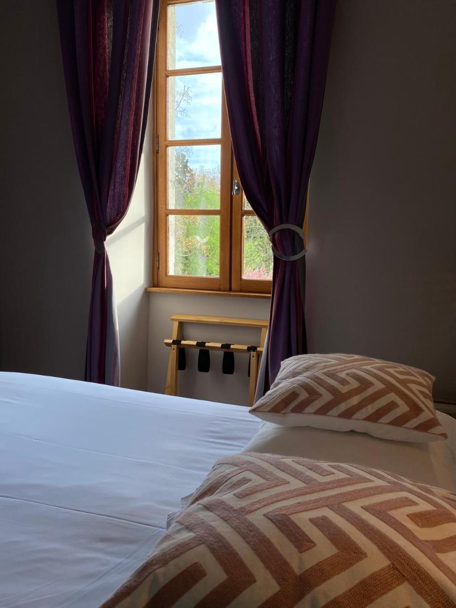 Un ou plusieurs lits dans un hébergement de l'établissement Logis Hôtel Château De Palaja