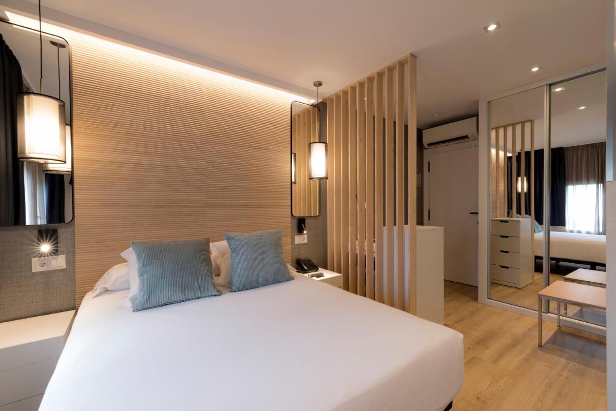 Cama o camas de una habitación en Hotel Avenida
