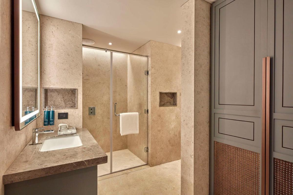 a bathroom with a sink and a shower at Doubletree By Hilton Bengaluru Whitefield in Bengaluru