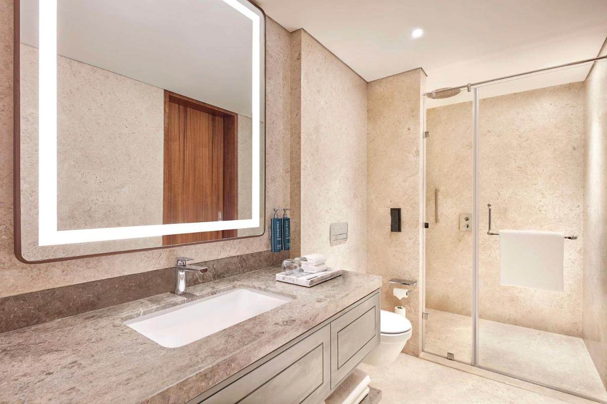 a bathroom with a sink and a shower at Doubletree By Hilton Bengaluru Whitefield in Bengaluru