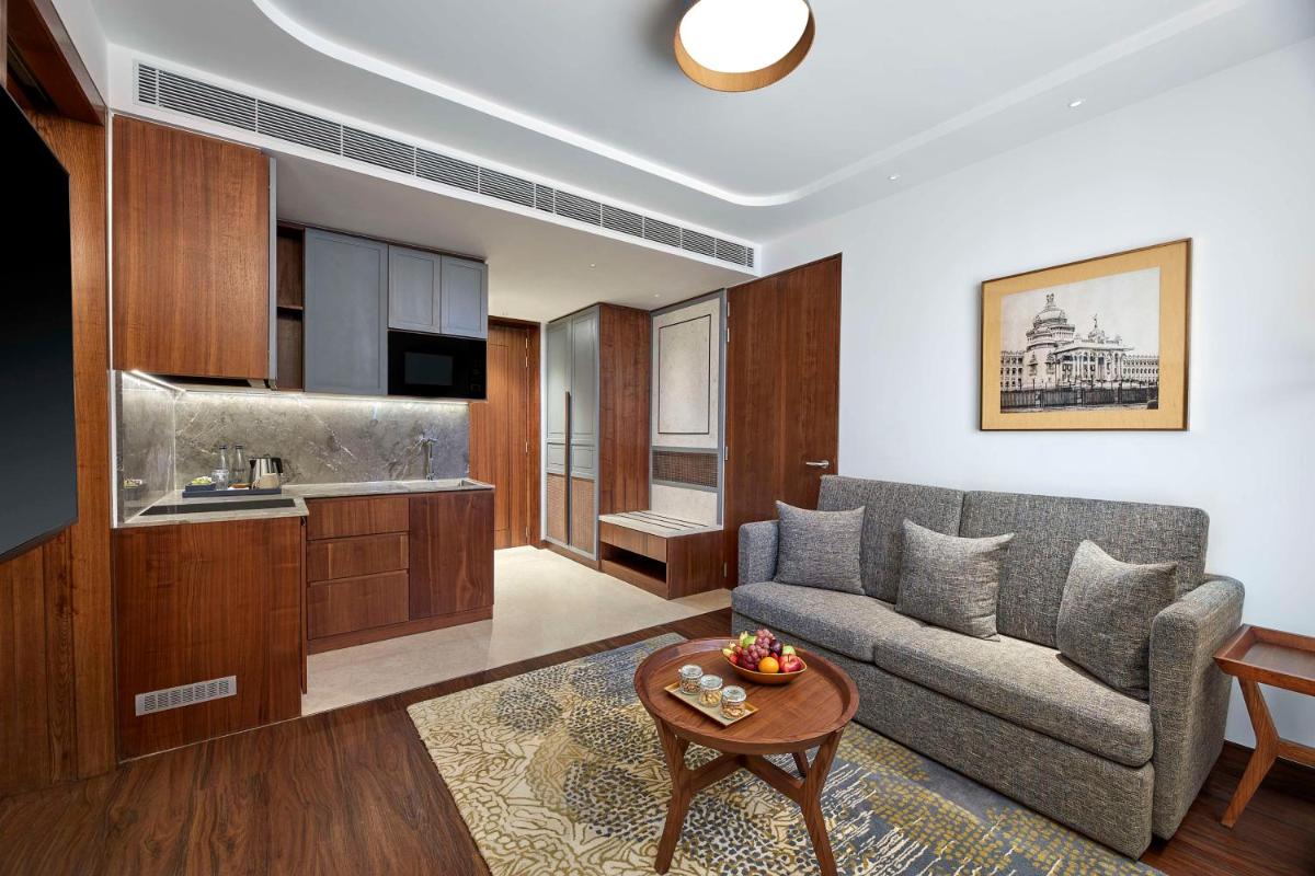a living room with a couch and a table at Doubletree By Hilton Bengaluru Whitefield in Bengaluru