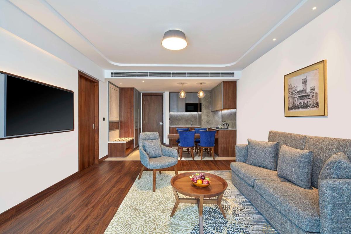 a living room with a couch and a table at Doubletree By Hilton Bengaluru Whitefield in Bengaluru