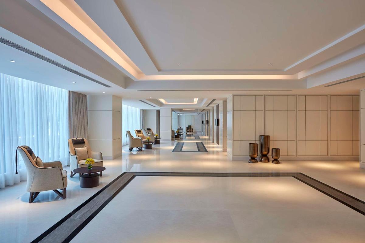 a lobby with a swimming pool in a hotel at Doubletree By Hilton Bengaluru Whitefield in Bengaluru